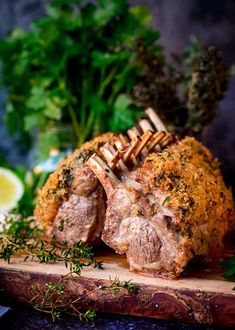 some meat on a cutting board with parsley and lemon wedges next to it