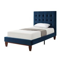 a bed that has a blue headboard and foot board on top of the bed