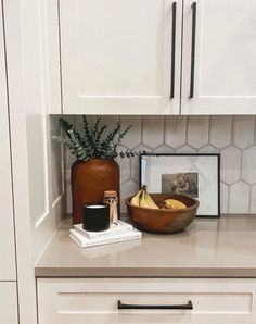 a bowl of bananas sitting on top of a counter