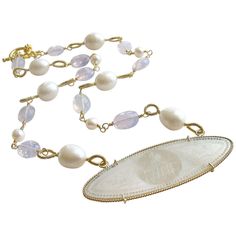 La Finesse Armorial Monogram Necklace. This beautiful and delicately carved Chinese gaming counter (circa 1810) has found a new life as the centerpiece of a stunning and elegant necklace of Lavender Moon Quartz and freshwater baroque pearls. The ethereal faceted oval Lavender Moonstone Quartz gemstones, with their shimmering aldurescent properties, alternate with creamy freshwater baroque pearls featuring hand-coiled loops. Safely suspended in a twist wire frame of 14k gold, this unique hand-engraved Mother-of-Pearl pendant is just as beautiful on the opposing side, featuring the same heraldic lion’s head monogram (FHM) on the reverse. During the early 1700’s, wealthy European families commissioned Chinese artisans to make finely engraved sets of mother-of-pearl gaming counters for use in Gambling Chips, Purple Flower Necklace, Monogram Pendant Necklace, Moon Quartz, Lavender Moon, Purple Pendant Necklace, Necklaces Beaded, Quartz Pendant Necklace, Lion Pendant