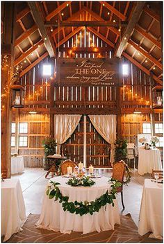 the inside of a barn decorated for a wedding