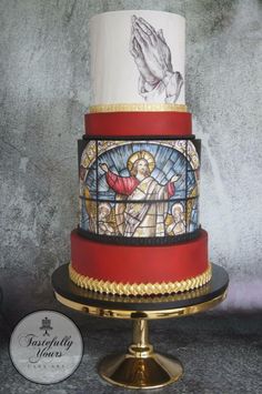 a three tiered cake decorated with stained glass and gold trim, depicting the crucifix