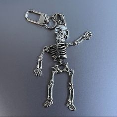 a skeleton keychain is shown on a shiny surface