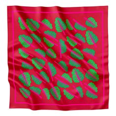 a pink and green scarf with leaf designs on the front, along with an orange background