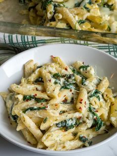 pasta with spinach and cheese in a white bowl