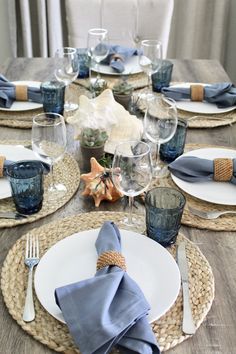 the table is set with place settings, napkins and silverware for two people