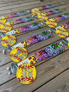 several skateboards are laid out on a wooden deck with stickers all over them