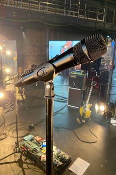 a microphone is sitting on top of a tripod in front of some other equipment