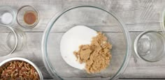 ingredients to make pecan pie laid out in bowls on a wooden table, top view