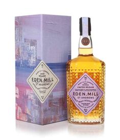 an empty bottle of eden mill single mal whisky next to a box on a white background