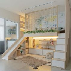 a room with stairs and plants growing on the wall next to an area rug that has been placed in front of it