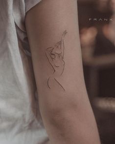 a woman's arm with a small tattoo on the left side of her arm