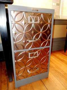 a metal cabinet sitting on top of a hard wood floor