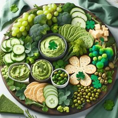 a wooden platter filled with different types of vegetables and dips on top of each other