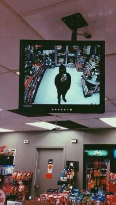 a television hanging from the ceiling in a store