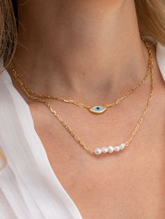 An evil eye necklace in gold color and oval shape and a longer necklace with five tiny freshwater pearls that are made both of them from sterling silver 925 in Greece. You can wear them together or separetely as well. In Christina Christi Jewels store you can see more than 100 designs in Women's Necklaces. You can have them in 2-4 Days with DHL EXPRESS SHIPPING MATERIALS - Gold Plated Chains made from Sterling Silver 925. - Five freshwater Pearls. - Evil eye is made from mother pearl. DIMENSIONS Danty Necklace, Gold Key Necklace, Gold Evil Eye Necklace, Tiny Pearl Necklace, Evil Eye Necklace Gold, Dainty Necklaces, Women Necklaces, Choker Pendant, Diamond Solitaire Necklace