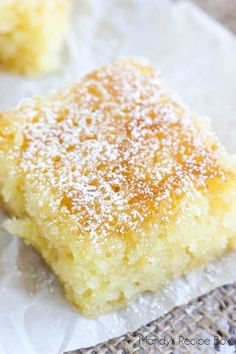 a close up of a piece of cake on a paper towel with powdered sugar