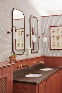 a bathroom with two sinks and three mirrors