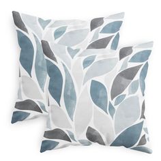 two pillows with blue and grey leaves on them