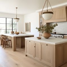 a kitchen with wooden cabinets and an island in front of a window that has a potted plant on it