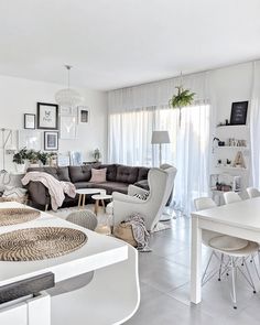 a living room filled with furniture and white walls