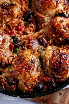 chicken with olives and rice in a skillet