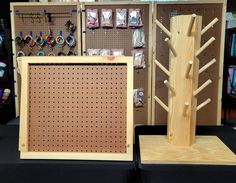 two wooden pegboards are next to each other in front of jewelry racks and earring holders