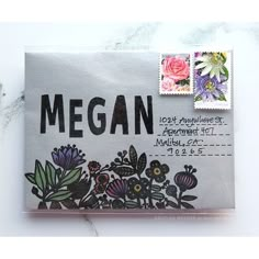 an envelope with stamps on it that says megan