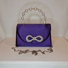 Womens purple top handle evening clutch bag with crystal bow embellishment, crystal and pearl detailed top handle, satin finish material and magnet front closing clasp Can be used with or without long shoulder chain (included) size approx- H 13cm x W 20cm Free Royal Mail delivery is an estimated 3-5 days but this can occasionally be slightly longer which solely on the Royal Mail side. We do offer guaranteed next day delivery but please contact us prior to ordering as this would incur a small upgraded shipping charge. We also offer WORLDWIDE shipping - please contact us for more info 💕🌍 Purple Clutch Evening Bag For Events, Purple Clutch Evening Bag For Formal Occasions, Elegant Purple Clutch Bag, Formal Purple Clutch Evening Bag, Elegant Purple Party Bag, Elegant Purple Clutch For Events, Elegant Purple Clutch For Event, Elegant Purple Evening Bag For Formal Occasions, Elegant Purple Evening Clutch