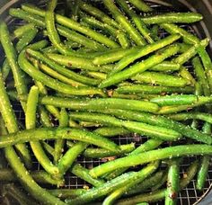 green beans are cooking in an air fryer