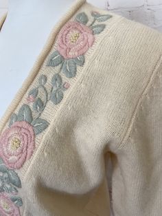 "Retro womens Evan Picone cardigan Pale pastel yellow sweater is nicely embroidered with light pink and green flowers and leaves Pearl buttons Excellent vintage condition. Slight hole at bottom front by side seam, hardly noticeable. See photo #6 (ribbed waist area) Tag size Medium 95% Lambswool 5% Nylon Measurements when laying flat across: Bust - 20\" Sleeve length - 21\" Length - 22.5\" Waist - 15\"" Vintage Embroidered Cream Cardigan, Vintage Cream Embroidered Cardigan, Vintage Cream Sweater With Floral Embroidery, Cream Embroidered Fitted Sweater, Fitted Cream Embroidered Sweater, Vintage Embroidered Beige Sweater, Vintage Beige Embroidered Sweater, Fitted Cream Sweater With Floral Embroidery, Fitted Embroidered Pink Cardigan