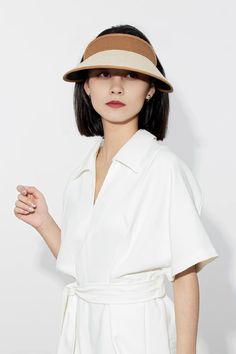 Stay effortlessly chic and protected with our adjustable UPF 50 wide-brim straw sun visor. Made with 100% paper straw and cotton-linen, it offers breathable comfort and stylish sun protection. Perfect for sunny days and outdoor adventures. Chic Spring Boater Hat Made Of Paper Straw, White Visor Bucket Hat For Vacation, Chic Natural Color Bucket Hat, Chic Natural Bucket Hat, Chic Bucket Straw Hat With Uv Protection, Chic Straw Bucket Hat With Uv Protection, Wide Brim Paper Straw Bucket Hat For Spring, Chic Beige Sun Hat For Summer, Chic Curved Brim Bucket Hat For Day Out