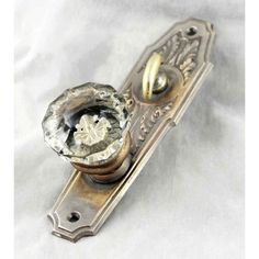 an antique door handle with a glass knob