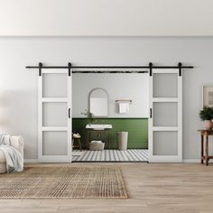 an open door leading to a bathroom with green tile and white walls, along with a rug on the floor