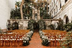 an outdoor ceremony setup with wooden chairs and flowers