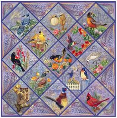 a quilt with many birds on it and flowers in the center, including oranges, blue