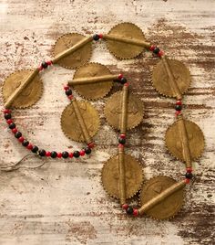 Beautiful Old Tribal Brass Disc Vintage Antique Necklace Old Tribal Jewelry Wearable Art Big bold beautiful Brass disk beads accompanied by small black and red resien spacer beads Very cool, wonderful to wear or keep in your special treasure box For a man or woman Necklace measures aprox 32 inches around each disc measures aprox 2 inches long by 1 1/2 inches wide Traditional Red Necklaces With Black Beads, Traditional Red Necklace With Black Beads, Bohemian Red Necklace With Black Beads, Traditional Red Beads For Festival, Red Wooden Beads For Festivals, Artisan Black Beads For Festivals, Red And Black Beaded Necklace For Festivals, Festival Gold Beads, Artisan Red Beads For Festival