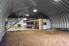 the inside of a large metal building with stairs