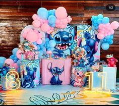 the birthday party is decorated with balloons and decorations, including an image of stitchy characters