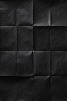 an image of black paper that looks like it has been folded in squares and is very dark