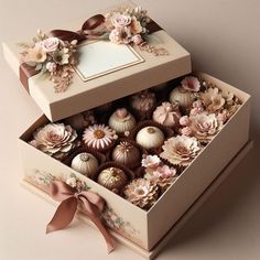 an open box filled with assorted chocolates on top of a table