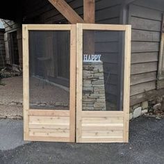 an open wooden door with the words happy written on it in front of a house