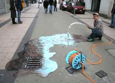 a man is spraying water on the street