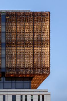 a tall building that has a lot of windows on it's side and is made out of bamboo