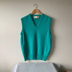 Sleeveless bright green pullover, sleeveless slip-over sweater , by Alan Paine, England. Ribbed v neck, armholes and welt. 100% lambswool. Will fit a chest 40 in 102 cm. Good vintage condition. Tiny hole on back, see photos, easily fixed.  Lovely colour and feel. For more vintage clothes and accessories, visit my shop https://www.etsy.com/uk/shop/coolclobber Classic Green V-neck Top, Casual Wool Sleeveless Vest, Wool Sleeveless Sweater Vest, Casual Sleeveless Wool Vest, Green V-neck Tank Top For Fall, Green Wool Crew Neck Top, Green V-neck Vest For Winter, Classic Solid Color V-neck Sweater Vest, Green Crew Neck Sweater Vest For Winter