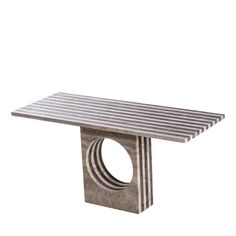 a table that is made out of concrete and has a circular design on the top