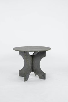 a round table made out of concrete on a white background