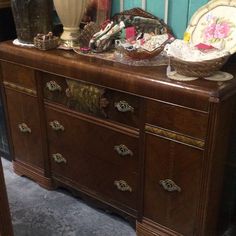 an old dresser with many items on it