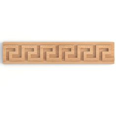 a wooden block with an intricate design on the front and back side, in light wood