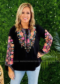 YOU'RE GOING TO LOVE COLORFUL EMBROIDERY ON THIS TOP! Black Bodice w/ Pink, Aqua, Yellow, and Multicolored Embroidered Print V-Neckline w/ Tassel Detail; Long Sleeves; Straight Hemline Lightweight Rayon Feel; We Feel Fits True to Size Bust Measured Laid Flat Across Front; Armpit to Armpit Small 19"; Medium 20"; Large 21"; 1XL 25"; 2XL 26"; 3XL 27" Length Measured Shoulder to Hemline Small 27"; Medium 27"; Large 28"; 1XL 30"; 2XL 31"; 3XL 32" 100% Rayon Models: Holly is wearing a Small; Lacey is Folk Style Multicolor Embroidered Top With Embroidered Hem, Eid Semi-stitched Resham Embroidery Tops, Folk Style Multicolor Embroidered Top, Folk-style Fitted Embroidered Top With Long Sleeves, Multicolor Embroidered Tops With 3/4 Sleeve, Eid Outfit, Stylish Clothes For Women, Plus Size Womens Clothing, Embroidered Top